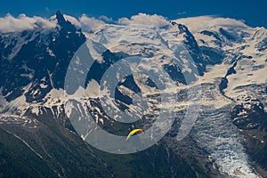 Paragliders looking for thermals amongst the snow caps of the Monte Blanc Massif, Chamonix,