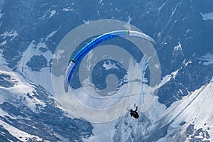 Paragliders looking for thermals amongst the snow caps of the Monte Blanc Massif, Chamonix,