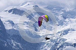 Paragliders looking for thermals amongst the snow caps of the Monte Blanc Massif, Chamonix,