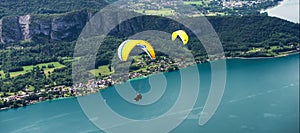 Paragliders with parapente jumping  near of lake of Annecy in French Alps, in France photo