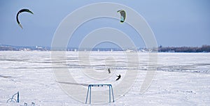 Paragliders sailing on frozen river  gliders blue sky. Snow Kiting. Winter sports