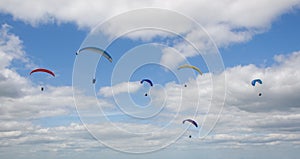 Paragliders soaring high in the sky
