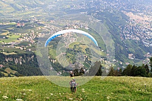 Paragliders start Paragliding in front of Merano panaroma in South Tyrol photo