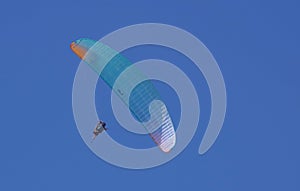 Paragliding against the blue sky photo