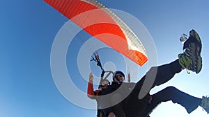 Paragliding against clear blue sky