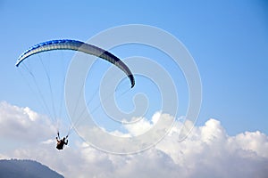 Paragliding in blue sky