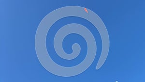 Paragliding on blue sky background