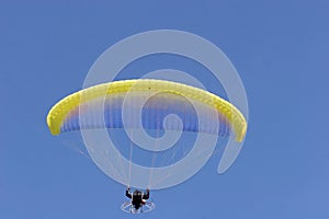 Paragliding on a blue sky. Sport in which the players fly in the air using paragliders