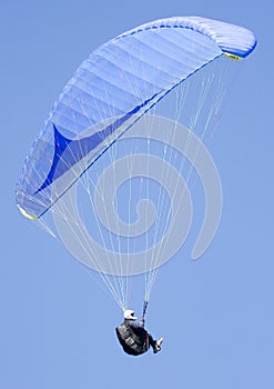 Paragliding in a clear blue sky