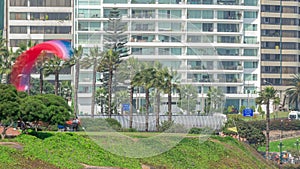 Paragliding on a cliff in Parque del Amor or Park of Love in Miraflores district timelapse. Lima, Peru photo