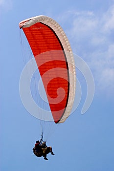 Paragliding duet high in the blue sky of San Diego over the pacific ocean