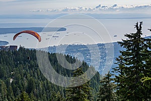 Paragliding flight with red glide and nice fluffy thermal clouds in background.