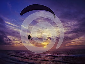 Paragliding flight at sunset