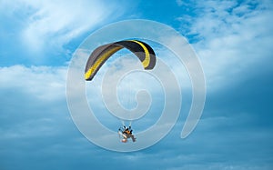 Paragliding fly on blue sky