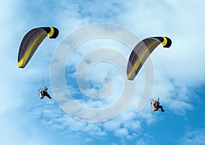 Paragliding fly on blue sky