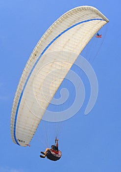 Paragliding high in the blue sky of San Diego over the pacific ocean.