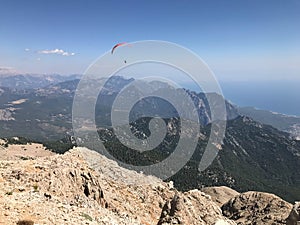 Paragliding in mountains. Freedom to fly in air over mountains with parachute. Paragliding behind blue sky Carpathian Mountains