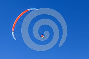 Paragliding in the mountains, People paragliding tandem above mountain in winter in Dombay ski resort. Concept of active lifestyle