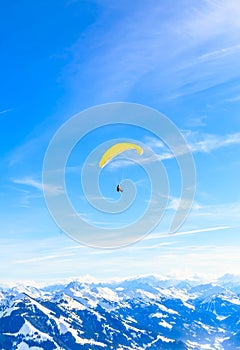 Paragliding over the mountains in winter. Ski resort Hopfgarten