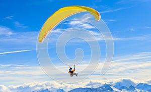 Paragliding over the mountains in winter. Ski resort Hopfgarten