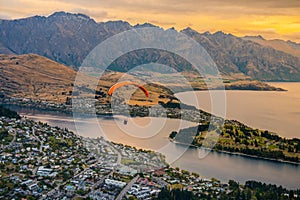 Paragliding over Queenstown and Lake Wakaitipu from viewpoint at Queenstown Skyline, New Zealand