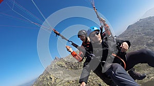 Paragliding over rocky hill