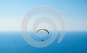 Paragliding over the sea with an instructor