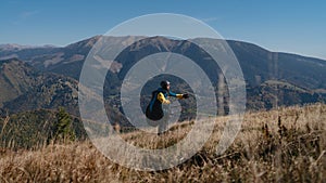 Paragliding pilot is preparing for flight in mountains.