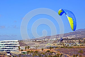 Paragliding in the sky.Paraglider flying over La Caleta village in south Tenerife island,Canary islands,Spain.