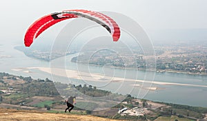 Paragliding in the sky. Paraglider  flying over Landscape from Beautiful View Mekong River