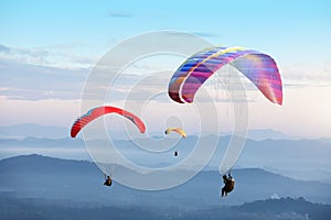 Paragliding in the sky. Paraglider  flying over Landscape sun set Concept of extreme sport