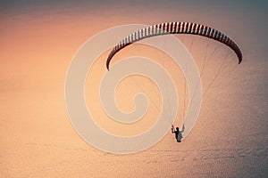 Paragliding in the sky at sunset. Paraglider flying over the Oludeniz Beach. Babadag, Fethiye, Turkey