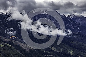 Paragliding in the Stubai Alps under cloudy skies