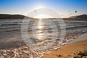 Paragliding summer beach water sports at sunset