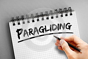 Paragliding text on notepad, concept background photo