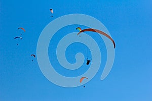 Paragliding under a blue sky in Nepal