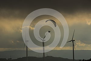 Paragliding between wind turbines in Anoia, Barcelona, Spain