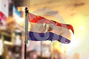 Paraguay Flag Against City Blurred Background At Sunrise Backlight photo