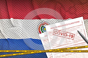 Paraguay flag and Health insurance claim form with covid-19 stamp. Coronavirus or 2019-nCov virus concept