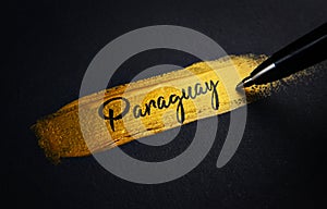 Paraguay Handwriting Text on Golden Paint Brush Stroke photo