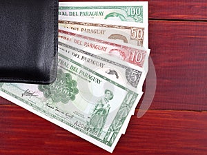 Paraguayan money in the black wallet photo