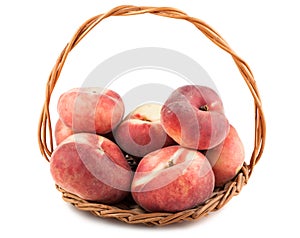 Paraguayos flat peaches in wicker basket