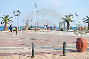 Paralia, Greece - September 26, 2017: People walking at the central square of Paralia in Greece. Perfect summer destination on the