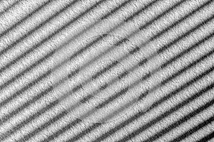 Parallel diagonal black and white gradient lines. Abstract background. Sun shutters shadow on wallpaper. Light and shade play