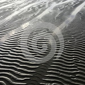 Parallel ridges of textured sand form intricate patterns, created by