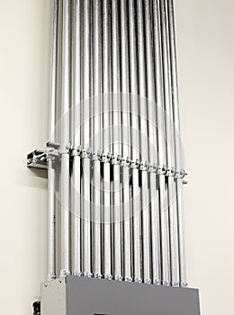 Parallel rows of electrical conduits from a distribution panel.