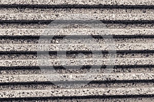 Parallel striped concrete wall of a bridge monochrome effect