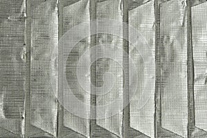 Paralleled chocolate bars in silver packaging on background