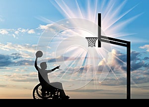 Paralympic disabled person in wheelchair playing basketball in afternoon