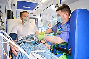 Paramedic administering medicine to a patient in an ambulance